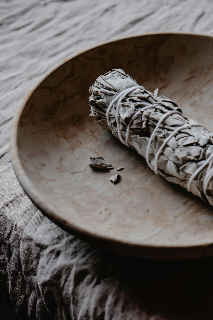 Sage bundle in a ceremonial bowl